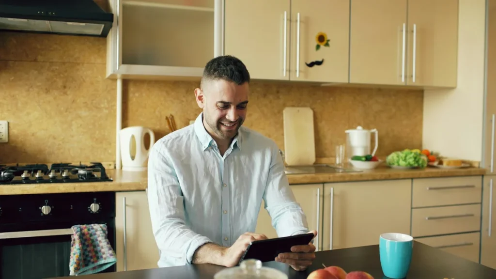 Restaurant owner smiling while reviewing POS options on a tablet
